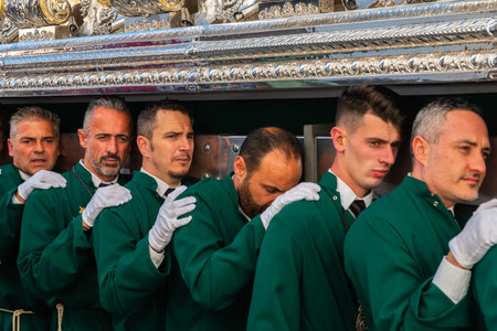 VELEZ-MALAGA, SPAIN - MARCH 29, 2018 People participating in the procession  in the Holy Week in a...