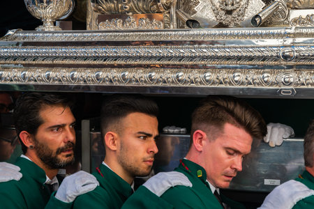 VELEZ-MALAGA, SPAIN - MARCH 29, 2018 People participating in the procession  in the Holy Week in a...