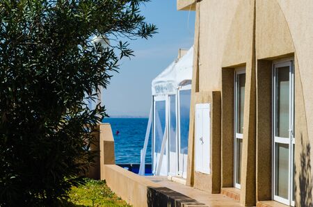 LA MANGA, SPAIN - MARCH 4, 2019  Outdoors restaurant near the beach in La Manga is a seaside spit in the Region of Murciaのeditorial素材