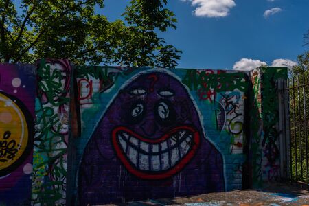 LONDON, UK - MAY 21, 2019 Grafitti on the wall in the city park, a place for legal painting with spray paints, street paintingのeditorial素材