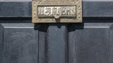 Old letterbox in the door, traditional way of delivering letters to the house, old mailbox,...