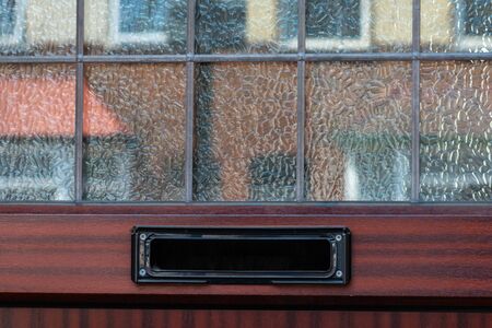 Old letterbox in the door, traditional way of delivering letters to the house, old mailbox, correspondenceの写真素材