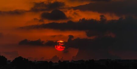 Red and orange dramatic colorful clouds lit by evening sunset light, sky landscapeの写真素材
