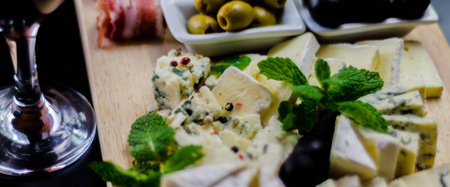 set of different cheeses on a wooden board, cheese board, delicious snack, healthy and exclusive...
