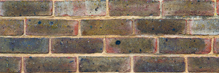 Old brick placed in the wall, interesting and original background, solid wall