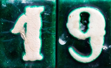 Decorative ceramic house number 19 tile on the wall, characteristic decorative element, numberの写真素材