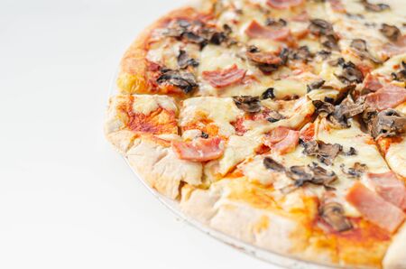 Freshly baked large pizza with ham, mushrooms and mozzarella on a traditional dough, typical Italian dishの写真素材