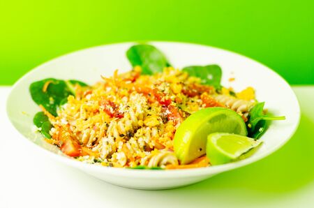 Tender paprika chicken with chilli and coriander wholewheat pasta, vegetables and a tingling sweet chilli dressing, tasty saladの写真素材
