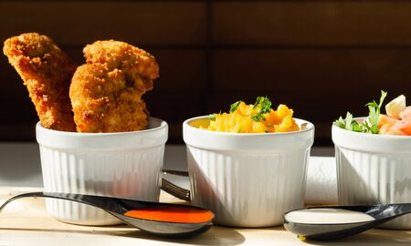 Breaded and herbed chicken breast fillet served with mash potatoes and tomato with onions, tasty foodの写真素材