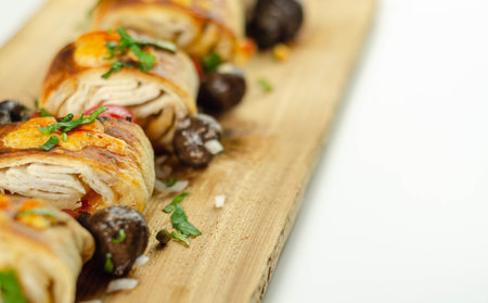 Baked pieces of tortilla wrap with chicken breast and Grana Padano cheese on the wood, mexican snack