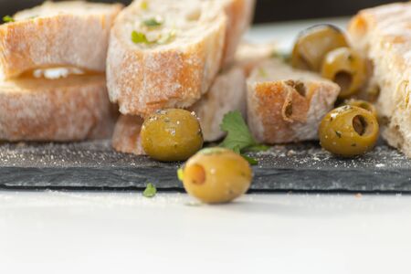 Close-up of pickled Spanish green olives served with fresh baguette, healthy foodの写真素材