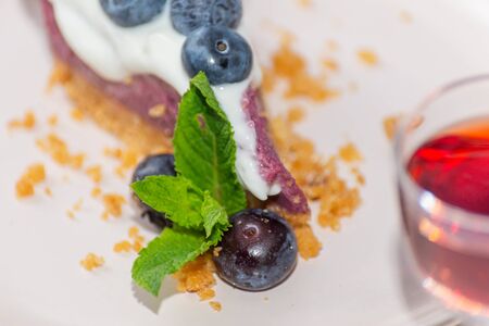 Close up on the baked vanilla and berries flavour cheesecake swirled with blueberry sauce on a digestive biscuit crumb, bakeryの写真素材