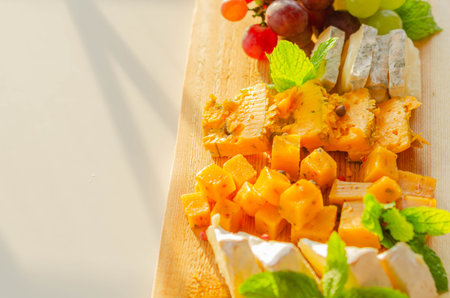 British hand-made and selected cheeses from local farms served on a wooden board, a unique set