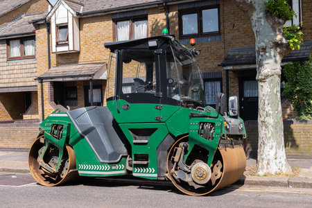 Heavy construction roller parked on an English city street, road works