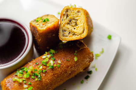 Delicious croquettes with sauerkraut and mushrooms served with hot red borscht, Eastern European...