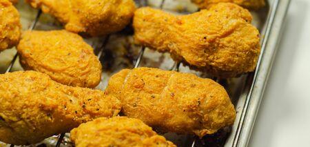 Southern crispy battered fried chicken wings, deep-fried chicken wings on the metal tray, fast foodの写真素材