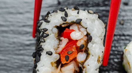 Close up of sweet chilli pawn and red pepper California roll, traditional Japanese foodの写真素材