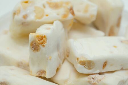 Traditional confections made with sugar or honey, roasted nuts and whipped egg whites, soft nougat barsの写真素材