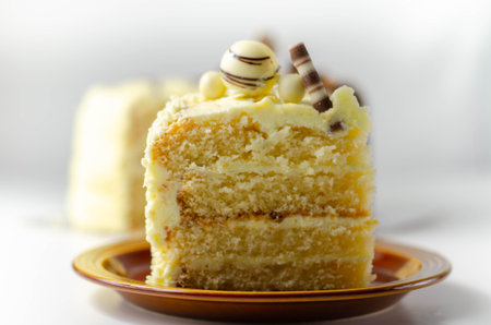 A piece of layered white cream cake with confectionery decorations, dessert for the celebration