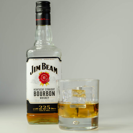 LONDON, UNITED KINGDOM - AUGUST 04, 2020 Straight bourbon whiskey by Jim Beam in a whiskey glass and...