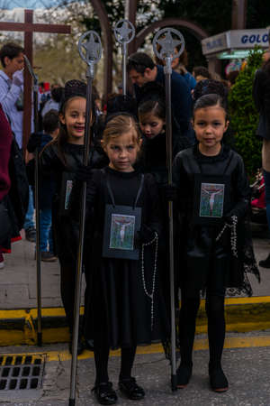 VELEZ-MALAGA, SPAIN, MARCH 24, 2018 Children participating in the procession associated with the holy week in a Spanish townのeditorial素材