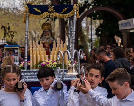 VELEZ-MALAGA, SPAIN, MARCH 24, 2018 Children participating in the procession associated with the holy week in a Spanish townのeditorial素材