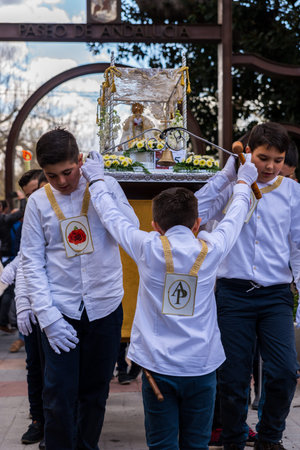 VELEZ-MALAGA, SPAIN, MARCH 24, 2018 Children participating in the procession associated with the...