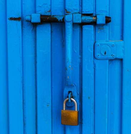 Lock bolt on blue metal gate, element for secure property lock, protectionの写真素材
