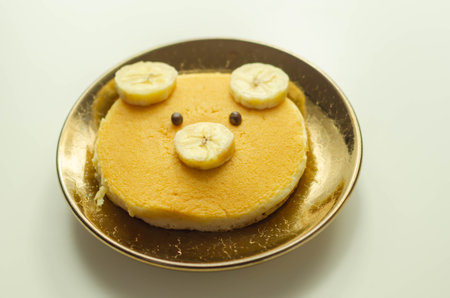Creative meal for a child, pancake with banana and chocolate  in a face little bear  shape, funny foodの写真素材