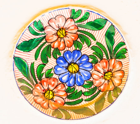 Traditional colorful wall decoration, hand-decorated ceramic plate hanging on the wall, craftsmanshipの写真素材