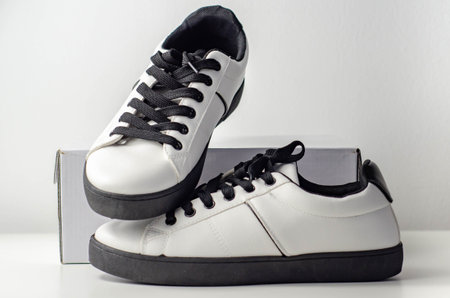 White sneakers with black laces, classic sports shoes, casual style