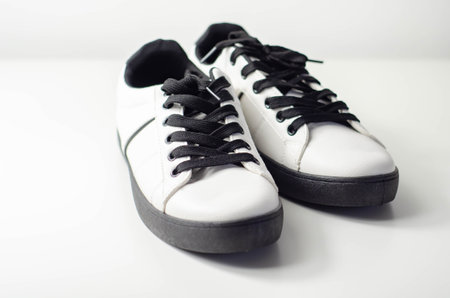 White sneakers with black laces, classic sports shoes, casual style