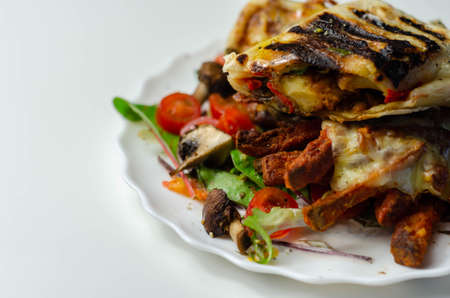 Grilled tortilla wrap with southern style chicken breast with sweet potato fries served on the mix salad, lunch timeの写真素材