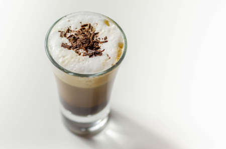 Coffee drink shot with a nutty note with fluffy milk foam, decorated with chocolate shavings, sweet drinkの写真素材
