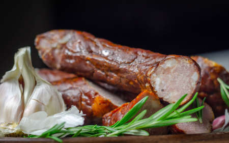 Traditional Polish juniper sausage on a wooden plate, luxury smoked product, delicious meatの写真素材