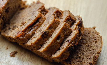 Freshly made spiced fruit  loaf cake  on the wooden  background, traditional British cake