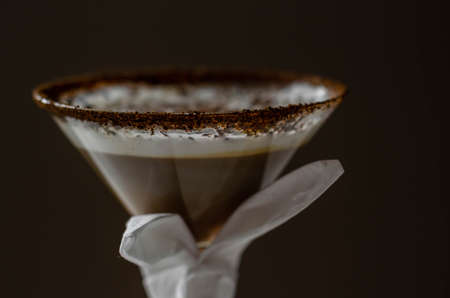 Coffee cocktail with a nutty note with fluffy milk foam, decorated with shavings of chocolate, served with an Easter bunny-shaped napkin, sweet drinkの写真素材