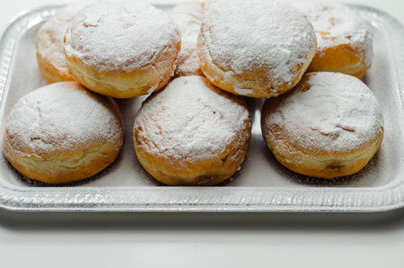 Berliner Pfannkuchen, a German donut, traditional yeast dough deep fried filled with chocolate cream...