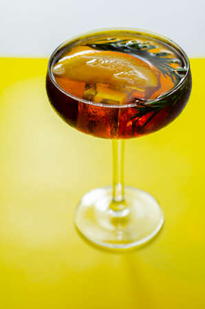 Refreshing cocktail based on gin and champagne and blood orange juice, served with a slice of orange and rosemary, luxury drinkの写真素材