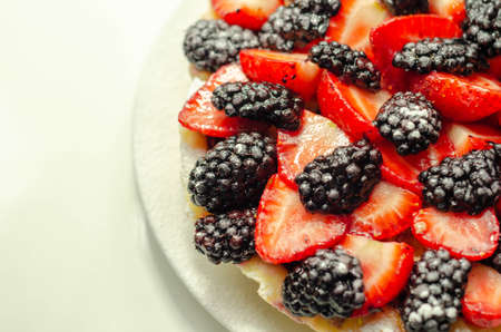 Butter enriched shortcrust pastry topped strawberries and blackberries, seasonal cake with colorful decoration, patisserieの写真素材