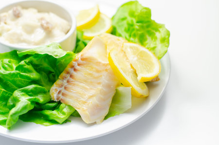 Steamed haddock fillet served with an exquisite salad consisting of cabbage, celery and apple with...