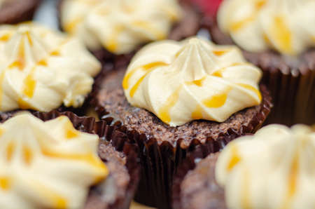 Salted caramel cupcakes, tempting little chocolate cupcakes with a flavour frosting and caramel drizzle, sweetsの写真素材