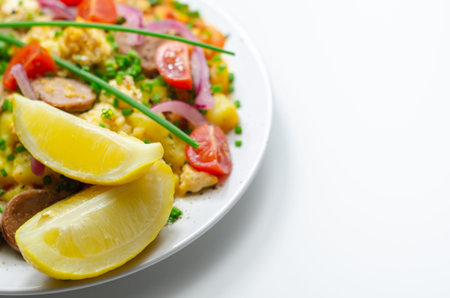 Haricot tomato bean sauce with turmeric potatoes, pork and herb sausage, and scrambled egg, brunchの写真素材