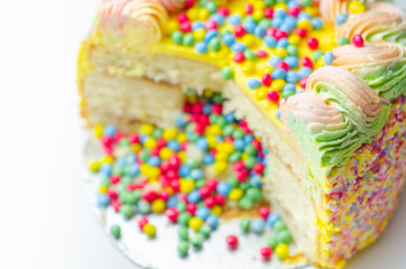 Madeira sponge coated with yellow colour frosting, layered with plum and raspberry jam, filled and...