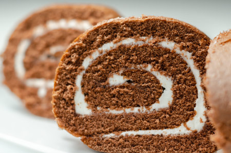 Chocolate sponge roll with a vanilla flavour filling, chocolate swiss roll, swirled cake