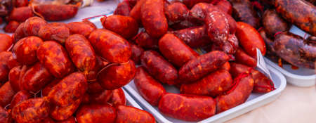 Typical Spanish sausages lying on a village stall at the food market, traditional meat productsの写真素材