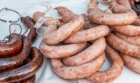 Typical Spanish sausages lying on a village stall at the food market, traditional meat productsの写真素材