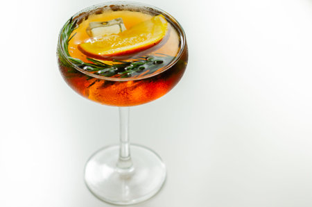 Refreshing cocktail based on gin and champagne and blood orange juice, served with a slice of orange...