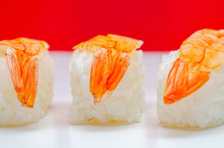 Closeup of ebi king prawn nigiri prepared by a Japanese chef in a restaurant, traditional asian foodの写真素材