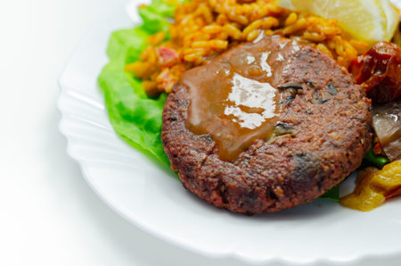 Meat free burger and long grain rice with red peppers, tomatoes and jalapeno chillies, vegetarian...